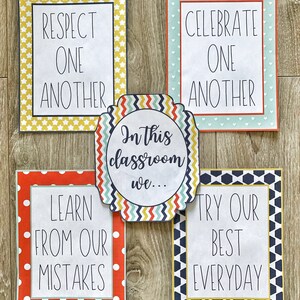 May include: Five colorful classroom posters with positive messages. The posters have decorative borders and include phrases like "Respect One Another," "Celebrate One Another," "Learn From Our Mistakes," and "Try Our Best Everyday." A central sign reads "In this classroom we..."