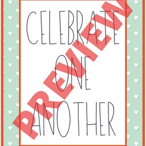 May include: A rectangular print with the words "CELEBRATE ONE ANOTHER" in a dark blue font. The print has a white background with a red border. The background has a light green color with white hearts.