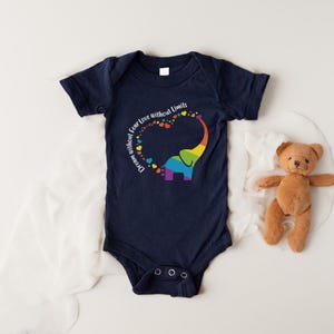 May include: Navy blue baby bodysuit with a rainbow elephant design. The elephant's trunk forms a heart shape filled with colorful hearts. The text "Dream without Fear Love without Limits" is printed on the bodysuit.