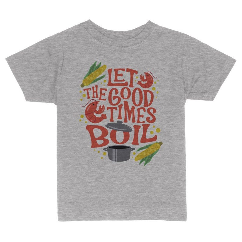 May include: Gray short-sleeved t-shirt with a red, yellow, and orange graphic that says "Let the good times boil". The graphic includes a pot, corn, and a crawfish.