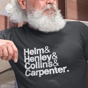 May include: Black t-shirt with white text that reads "Helm & Henley & Collins & Carpenter." The shirt is made of a soft material and has a classic crew neck. The text is in a clean, sans-serif font.