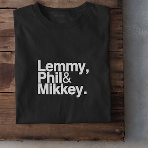 May include: Black t-shirt with white text that reads "Lemmy, Phil & Mikkey."