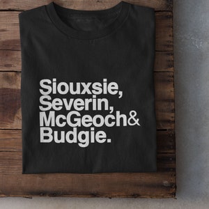 May include: Black t-shirt with white text that reads "Siouxsie, Severin, McGeoch & Budgie."