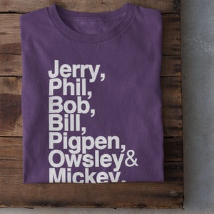 May include: Purple t-shirt with white text that reads "Jerry, Phil, Bob, Bill, Pigpen, Owsley & Mickey."