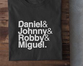Puede incluir: Una camiseta negra con texto blanco que dice "Daniel & Johnny & Robby & Miguel."