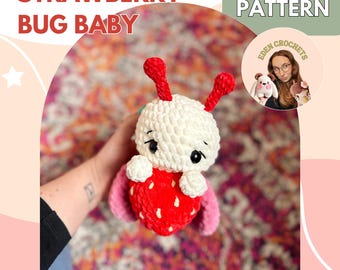 May include: A handmade crochet Strawberry Bug Baby plushie. The plushie has a white head, red antennae, and a red strawberry body with pink wings. The text "STRAWBERRY BUG BABY" is at the top left. The text "CROCHET PATTERN" is at the top right.