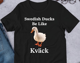 May include: Black t-shirt with white text that reads "Swedish Ducks Be Like" and a white duck image with the text "Kväck" below the image.