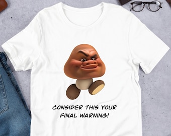 以下が含まれることがあります： 「CONSIDER THIS YOUR FINAL WARNING!」というテキストと、しかめっ面をした茶色のキノコのキャラクターが描かれた白いTシャツ