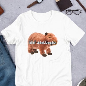 May include: White t-shirt with a brown capybara wearing a white shirt with the text "Full of violent thoughts" printed on it.