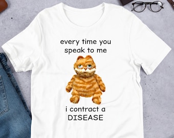 May include: White t-shirt with a cartoon orange cat and the text "every time you speak to me i contract a DISEASE"