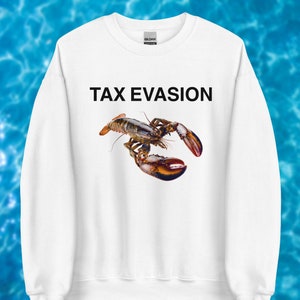 May include: White sweatshirt featuring the words "TAX EVASION" above a detailed image of a lobster. The lobster is depicted in shades of brown, orange, and black. The sweatshirt is a Gildan brand.