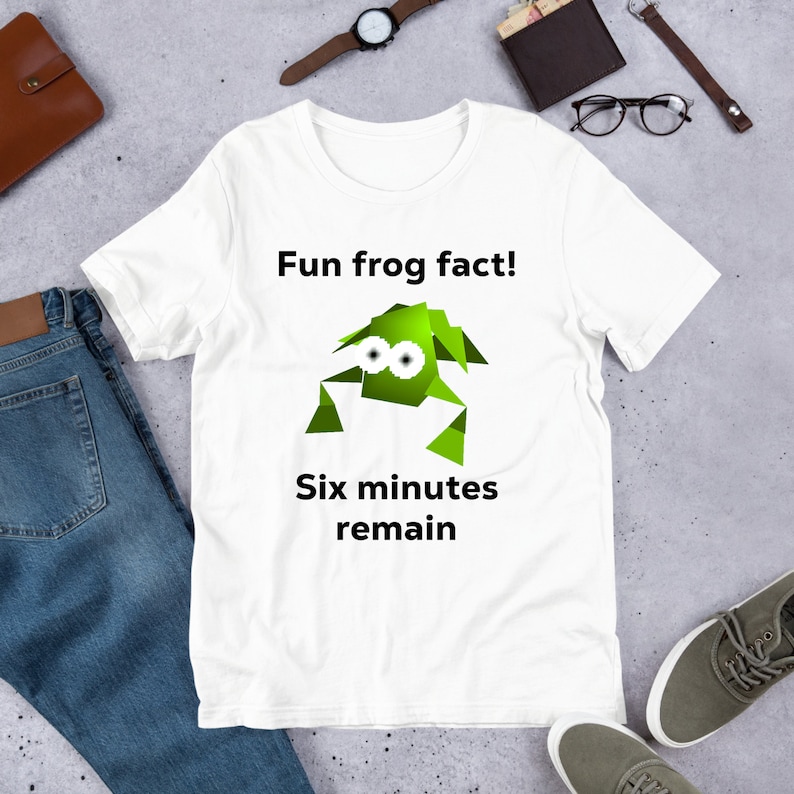 May include: White t-shirt with a green cartoon frog and the text "Fun frog fact! Six minutes remain."