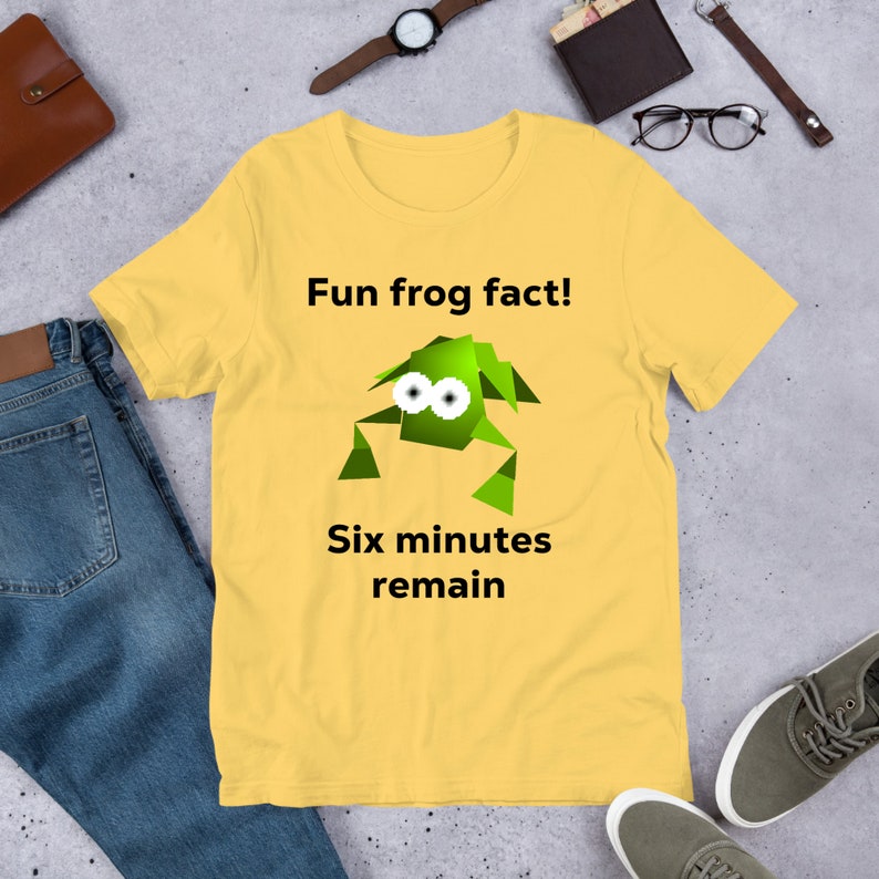 May include: Yellow t-shirt with a green cartoon frog and the text "Fun frog fact! Six minutes remain."