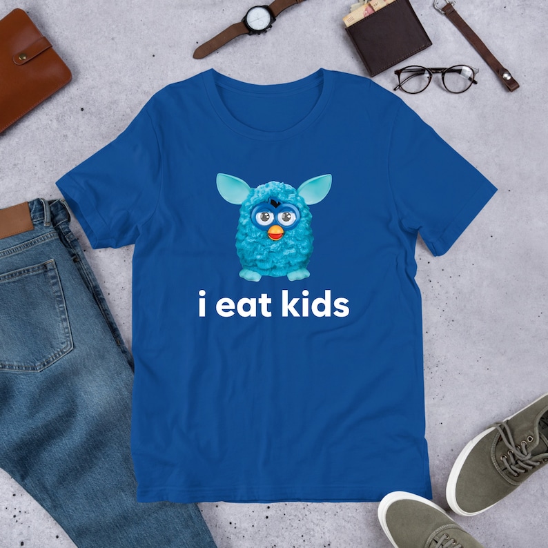 May include: A blue t-shirt with a cartoon blue fuzzy creature with googly eyes and the text "i eat kids".