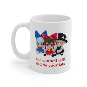 May include: White ceramic mug featuring a colourful illustration of three anime characters. The text "the council will decide your fate" is printed in red below the characters.