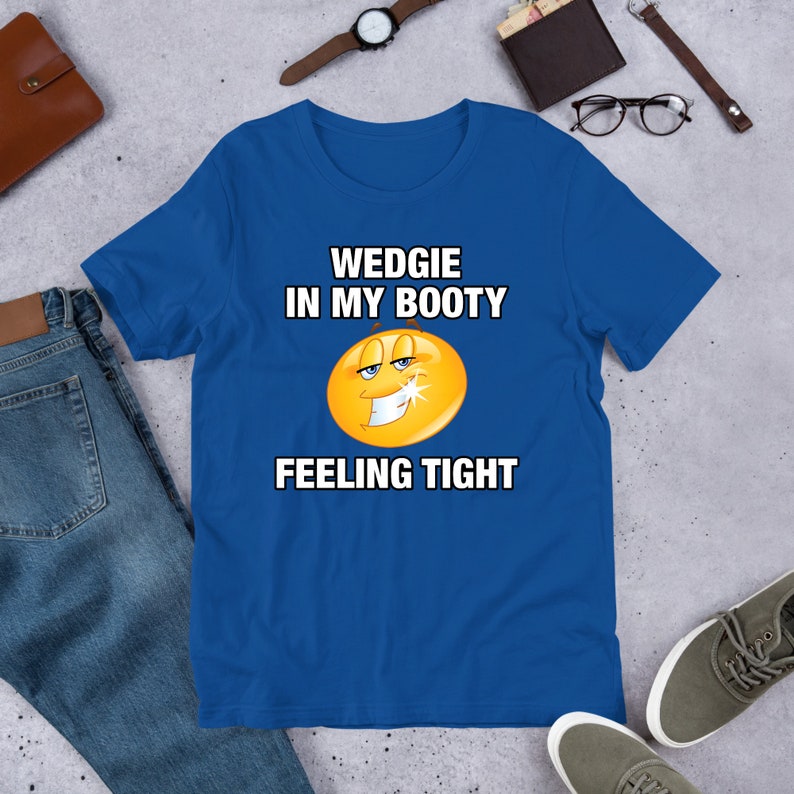 May include: A royal blue t-shirt with a yellow smiley face and the text "WEDGIE IN MY BOOTY FEELING TIGHT".