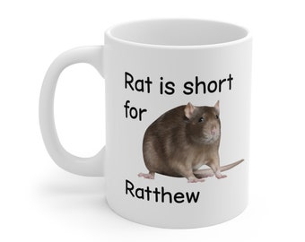 May include: White ceramic mug featuring a brown rat illustration and the text "Rat is short for Ratthew".