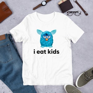 May include: White t-shirt with a blue fuzzy creature with big eyes and the text "i eat kids" printed on it.
