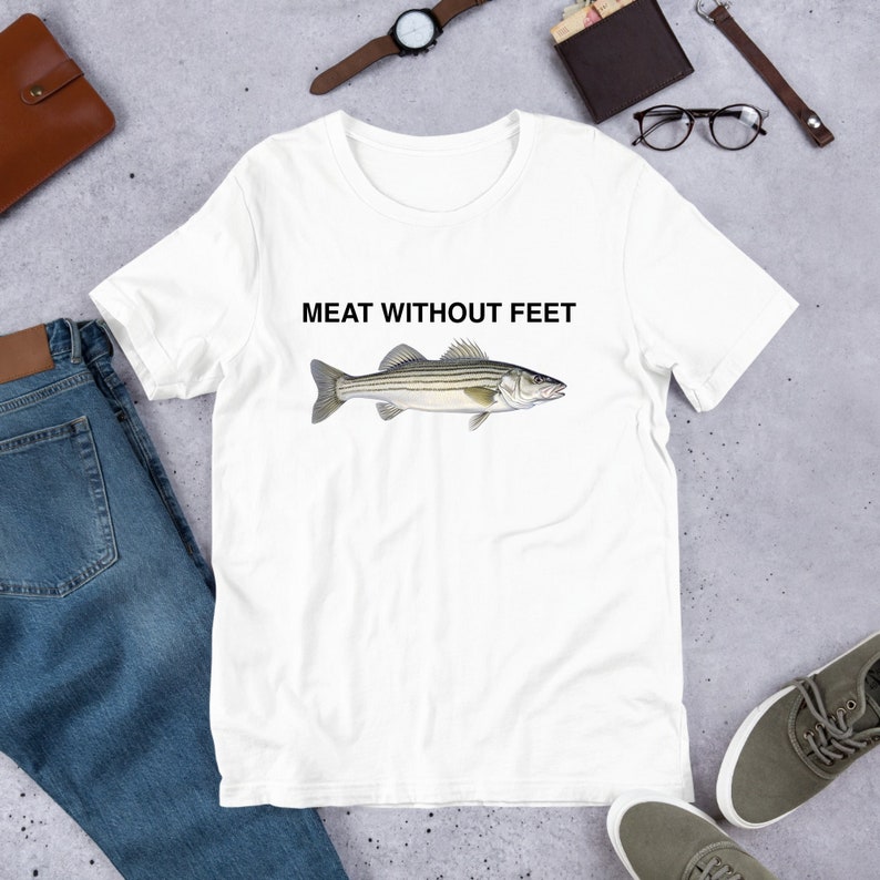 May include: White t-shirt with a striped fish illustration and the text "MEAT WITHOUT FEET" printed on the front.