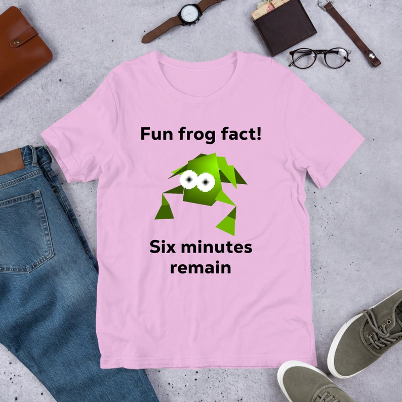 May include: Pink t-shirt with a green cartoon frog and the text "Fun frog fact! Six minutes remain."