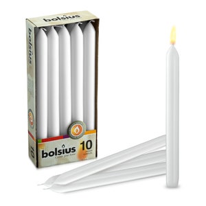 May include: A box of 10 white dinner candles by Bolsius. The candles are 30 cm long and are packaged in a box with a brown and white design. The box has the text "Bolsius Colour your home" and "10 Dinner Candles" printed on it.