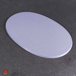 Könnte beinhalten: Eine hellviolette, ovale Basis mit strukturierter Oberfläche. Die Basis besteht aus einem festen Material und hat einen glatten, abgerundeten Rand. Das Produkt ist für die Präsentation oder als Stütze konzipiert.