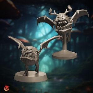 Peut inclure: Deux figurines grises de créatures fantastiques. L'une est debout sur une base ronde, l'autre est montée sur un socle. Les deux ont des ailes de chauve-souris, des dents pointues et une expression menaçante. L'arrière-plan est une scène de forêt floue.