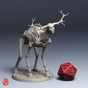 May include: A light grey miniature figurine of a skeletal deer-like creature with a human-like skull, large antlers, and exposed ribcage, standing on a circular stone-textured base next to a red twenty-sided die for scale reference.