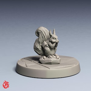 May include: A grey, unpainted miniature figurine of a squirrel sitting on a rock base. The squirrel has a large, bushy tail, pointed ears, and is holding a small object to its mouth. It wears a small satchel on its side and rests on a circular base.