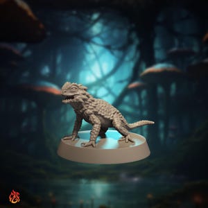 May include: A detailed, gray lizard figurine with textured scales and a spiky dorsal ridge, posed on a circular base. The creature has an open mouth, revealing teeth. The background features a blurred forest scene with mushrooms.