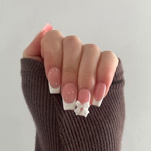 French tip fiocco, unghie finte, unghie carine alla moda, unghie finte, unghie finte, unghie fiocco, french tip, unghie fiocco bianco