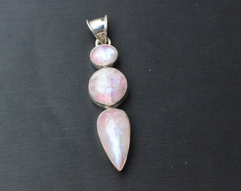 May include: A silver pendant with three iridescent moonstone stones. The stones are a teardrop shape, a round shape, and a smaller round shape. The pendant is on a black background.
