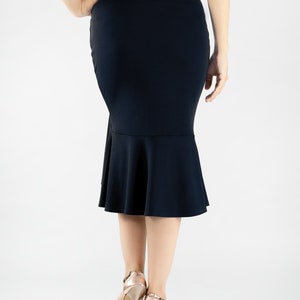 May include: A navy blue skirt with a fitted silhouette and a flared hemline. The skirt is knee-length and has a smooth, stretchy fabric.