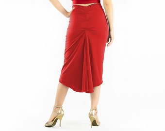 May include: A red skirt with a gathered back panel and a flowing hemline. The skirt is made of a soft, stretchy fabric and is ideal for dancing or casual wear.