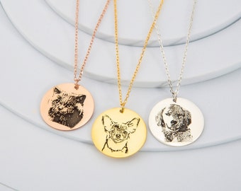 May include: Three silver necklaces with round pendants featuring engraved images of a cat, a chihuahua, and a dog. The necklaces are displayed on a white background.