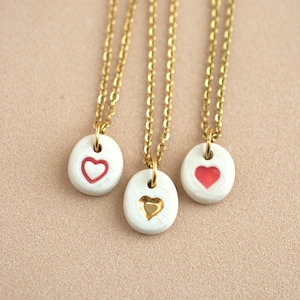 Small, simple heart necklace. Cute, everyday ceramic pendant with a mini heart in red and gold. Handmade ceramic jewelry.