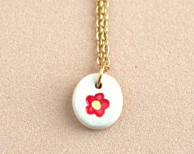 Small red floral pendant necklace. Simple hand-painted ceramic flower pendant. Handmade ceramic jewelry for everyday wear.