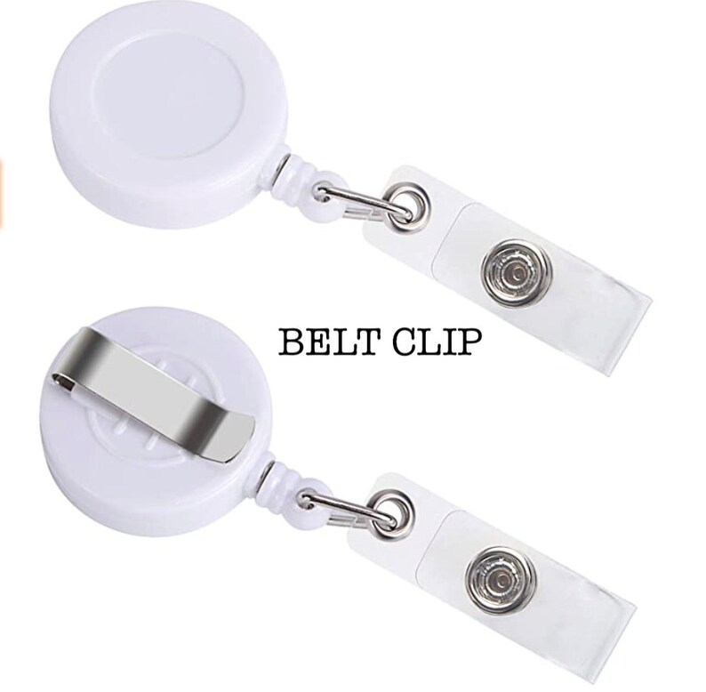 May include: White retractable badge holder with a belt clip. The holder has a clear plastic strap with a button on one end.
