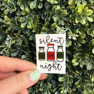 May include: White sticker with the text "silent night" and three cartoon bottles labeled "versed", "ativan", and "propofol".
