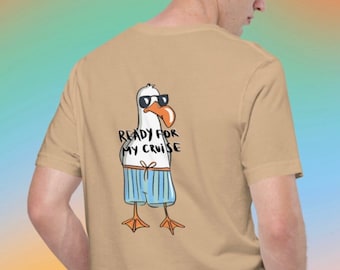 May include: A tan t-shirt with a cartoon seagull wearing sunglasses and blue swim trunks. The seagull has the text "Ready for my cruise" written on it.