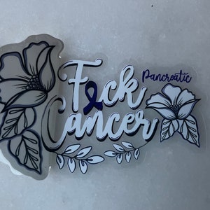 May include: White sticker with the text "F*ck Cancer" in a stylized font with a blue ribbon. The text "Pancreatic" is above the word "Cancer". The sticker is decorated with black and white floral designs.