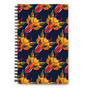 May include: A spiral notebook with a dark blue cover featuring a repeating pattern of stylised orange, yellow, red, and blue wolf heads.