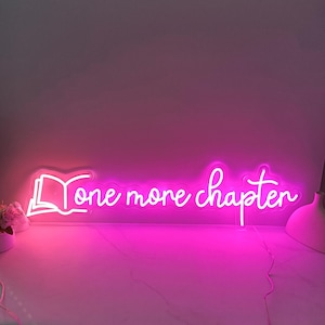 May include: Pink neon sign with the text "one more chapter" and a stylized image of an open book.
