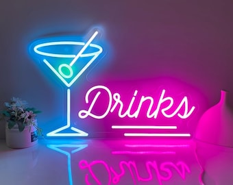 May include: Neon sign with a blue martini glass and the word "Drinks" in pink neon.