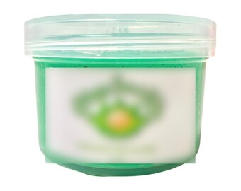 May include: A clear plastic container filled with a bright green slime-like substance. The container has a white label with a blurred green logo.
