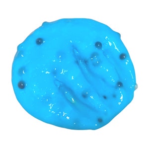 May include: A close-up of a bright blue slime with small black specks throughout.