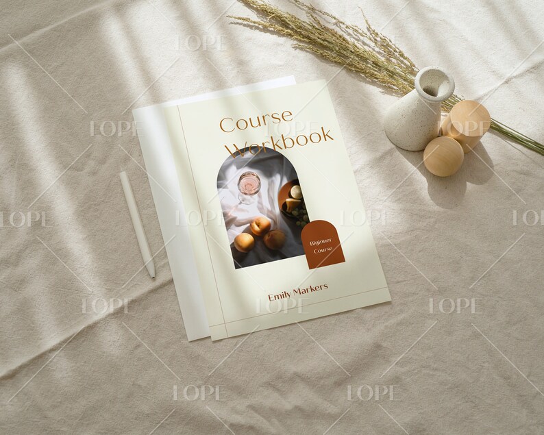 May include: A beige and brown workbook titled "Course Workbook" with a photo of fruit and a glass of wine in an archway. The text "Beginner Course" is in a brown circle at the bottom of the page. The author's name, "Emily Markers", is printed below the title.