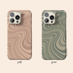 May include: Two phone cases with a wavy pattern. One is pink with a light brown design, and the other is green with a darker green design. The word "pink" is written below the pink case, and "green" is written below the green case.