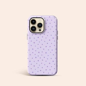 May include: A lavender phone case with a repeating pattern of small, light purple stars. The case has a glossy finish and a camera cutout with three lenses. The phone case is designed to fit a smartphone.