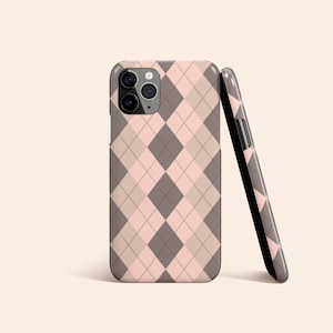 May include: A pink and grey argyle patterned phone case for an iPhone.